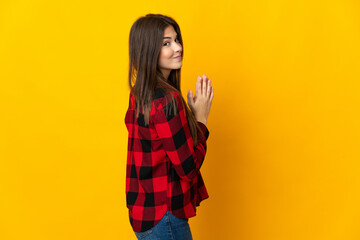 Teenager Brazilian girl isolated on yellow background scheming something