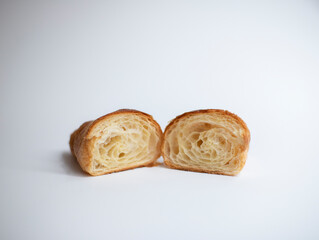Split croissant on white background