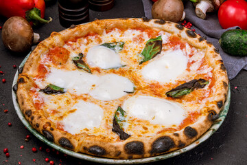 Italian pizza Margherita on black table