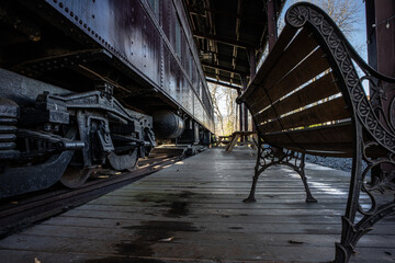 An obsolete train carriage and a discarded passenger platform
