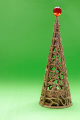 Christmas tree with a red ball on the end and green background.