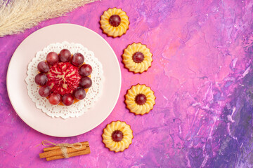 Fototapeta na wymiar top view little cookies with cake on pink background sweet biscuit color