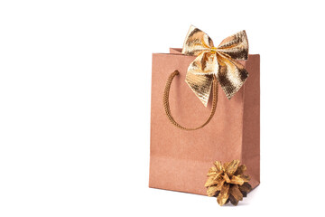Paper shopping bag golden fir cone on white background. The concept of Christmas sales.