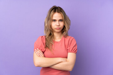 Teenager Russian girl isolated on purple background feeling upset