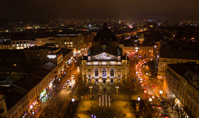 Fototapeta premium Aerial view on Lviv Opera at night from drone