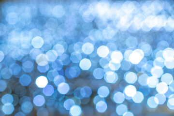 Bokeh background Blue glitter abstract lights. Festive blur. Defocused winter backdrop.