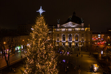 Fototapeta na wymiar Opening of Christmas tree near Opera House in Lviv, Ukraine. View from drone