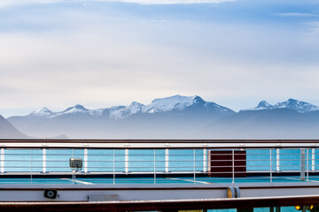 A view of snow-capped mountains along the coast of Alaska, seen from the deck of a cruise ship