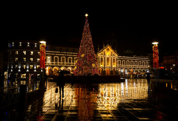 Fototapeta na wymiar Christmas city lights decoration with an enormous Christmas tree in a rainy night, Braga, Portugal.