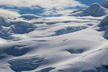 Fototapeta na wymiar Snow-covered dunes on the mountains in Antarctica. Clouse-up.