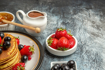 front view yummy pancakes with honey and fruits on light background fruit cake sweet