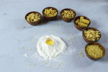 ingredients for homemade pasta. Food background: macaroni, spagetti, egg, flour