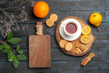 top view cup of tea with fruits and cookies on a dark desk ceremony sweet biscuits sugar
