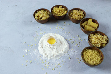 ingredients for homemade pasta. Food background: macaroni, spagetti, egg, flour