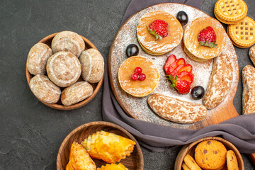 top view yummy pancakes with fruits and sweet cakes on a dark background dessert sweet cake