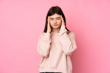 Young Ukrainian teenager girl over isolated pink background with headache