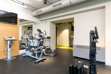 Fototapeta na wymiar Interior of a modern hotel gym with equipment