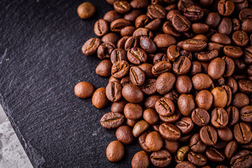 aromatic fresh coffee beans on a dark stone background