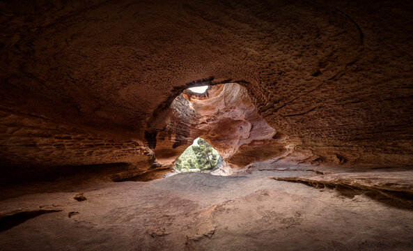 Great mountain cave. Top of the cavern. Image of a cave with a large entrance and a hole or window at the top. Panoramic view of a Neolithic cave. Cave carved in Murcia, Spain