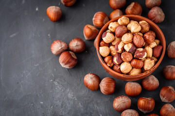 fresh natural hazelnuts on a dark stone background