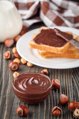 toasts with chocolate butter on a dark wooden rustic background
