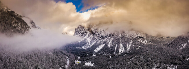 Aerial of mountains in styria, Green lake Gruner see cloudy winter day tourist destination