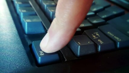 Pressing the Esc key on a computer keyboard. A macro view of an escape button typing with a finger on a computer. Concept of panic, interruption, abort and problem solve.