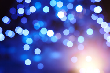 Christmas tree with garlands out of focus. bokeh of many blue lights