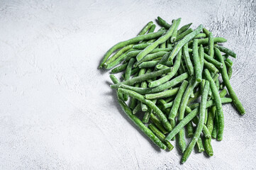 Frozen green beans on the white kitchen table. White background. top view. Copy space