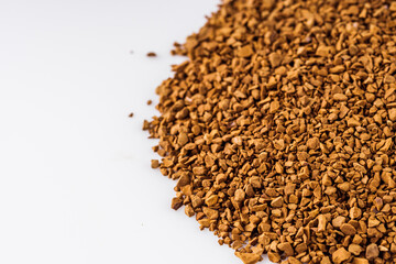 instant coffee granules on a white acrylic background