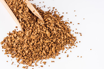 instant coffee granules on a white acrylic background