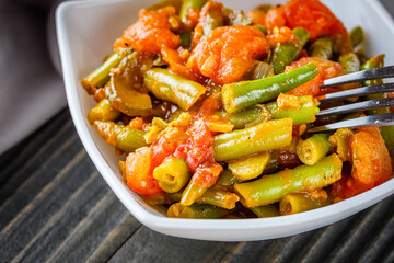 stewed green beans on a dark wooden rustic background