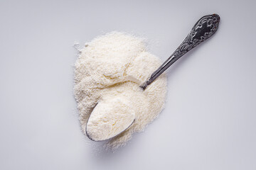 granulated milk powder on a white acrylic background