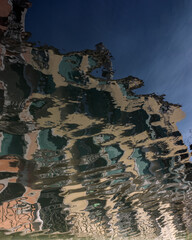 VENICE, ITALY:  Reflection with ripples of old building in canal for use as a background or texture
