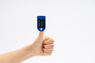 Finger pulse oximeter. On white background. The device is put on the thumb up. Health diagnostics