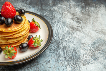 front view delicious pancakes with fruits and berries on dark desk fruit cake dessert