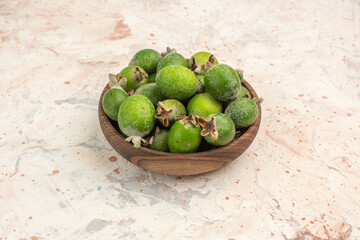 Top view of a pot full of fresh feijoa a small green vitamin bomb on white background