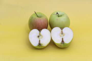 A few apples on yellow background, benefits of apples concept