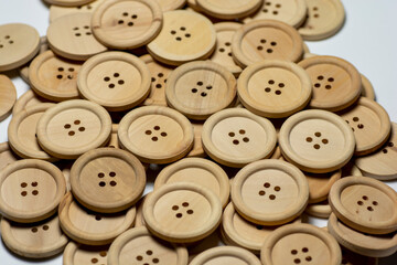 Natural round wooden sewing buttons isolated on white background. Close up. Macro.