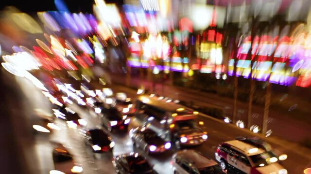 Selective focus image of the electricity and energy of bright lights and traffic on the strip at night in Las Vegas, Nevada.