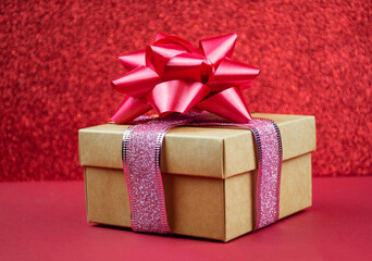 surprise gift with red bow on bokeh background for winter holiday