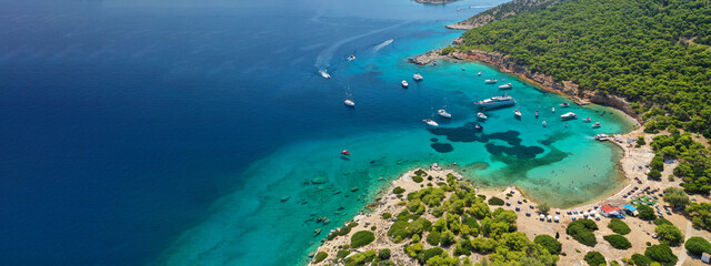 Aerial drone ultra wide photo of exotic bay of Moni island visited by yachts and sail boats, Aegina...