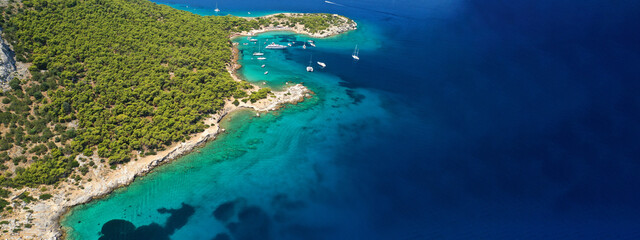 Aerial drone ultra wide photo of exotic bay of Moni island visited by yachts and sail boats, Aegina island, Saronic gulf, Greece