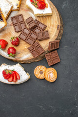 top view cake slices with choco bars and cookies on grey desk biscuit fruit sweet