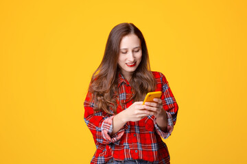 Young woman smiling and using smartphone