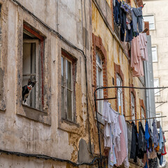 Fototapeta na wymiar clothes hanging out to dry in the narrow streets of run-down noeighboorhod in Portugal
