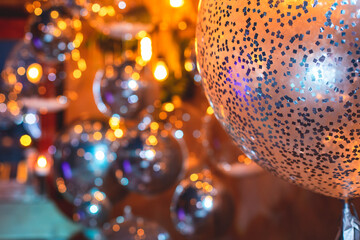 Decoration interior elements of restaurant venue banquet hall with multicoloured different helium balloons, on a indoor corporate event or wedding reception or birthday party celebration