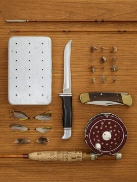 Studio shot of flyfishing equipment on wooden table