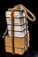 Thick books tied with a strong rope. A thick line around the paper.