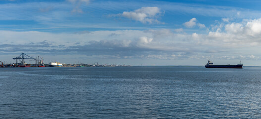 Fototapeta premium panorama of harbor cranes and industrial port and freight ship in Setubal on the Sado River